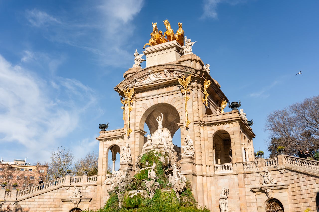 Low angle of aged historic construction with columns and arched entrances decorated with sculptural ensemble with quadriga of Aurora in Citadel Park