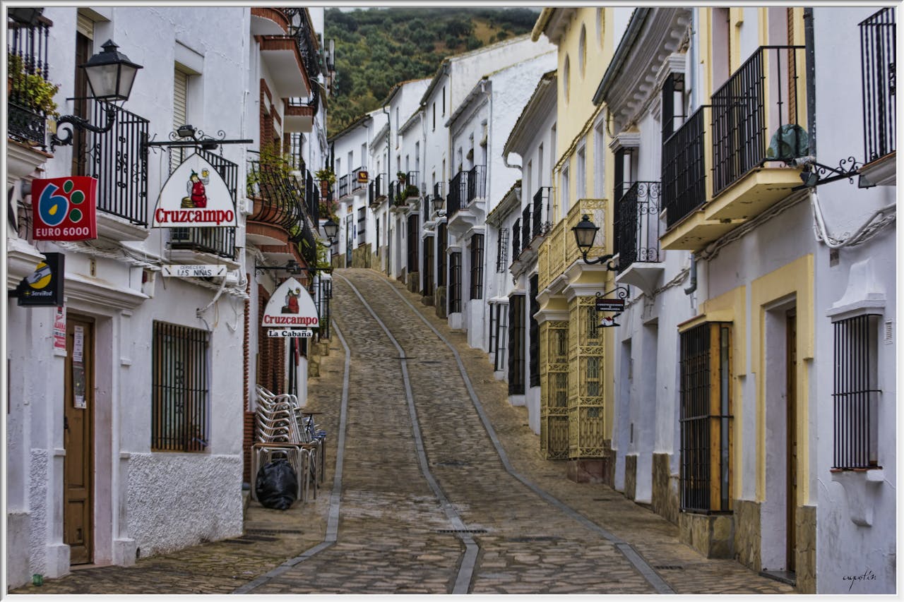 Picturesque historic street view in Zahara de la Sierra, Andalusia, featuring traditional white buildings.